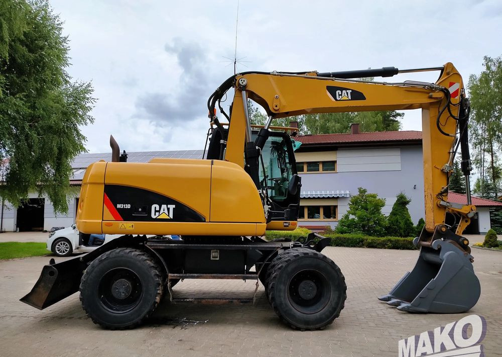 Caterpillar M313D - Ekskavator roda: gambar 5 Caterpillar M313D - Ekskavator roda: gambar 5