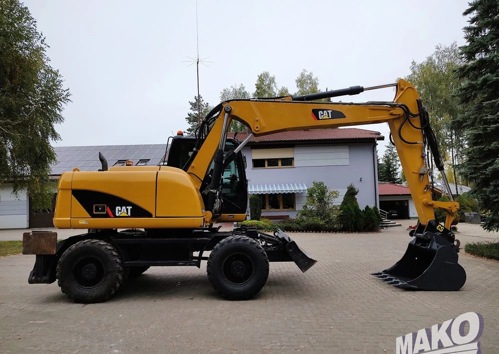Caterpillar M313D - Ekskavator roda: gambar 5 Caterpillar M313D - Ekskavator roda: gambar 5