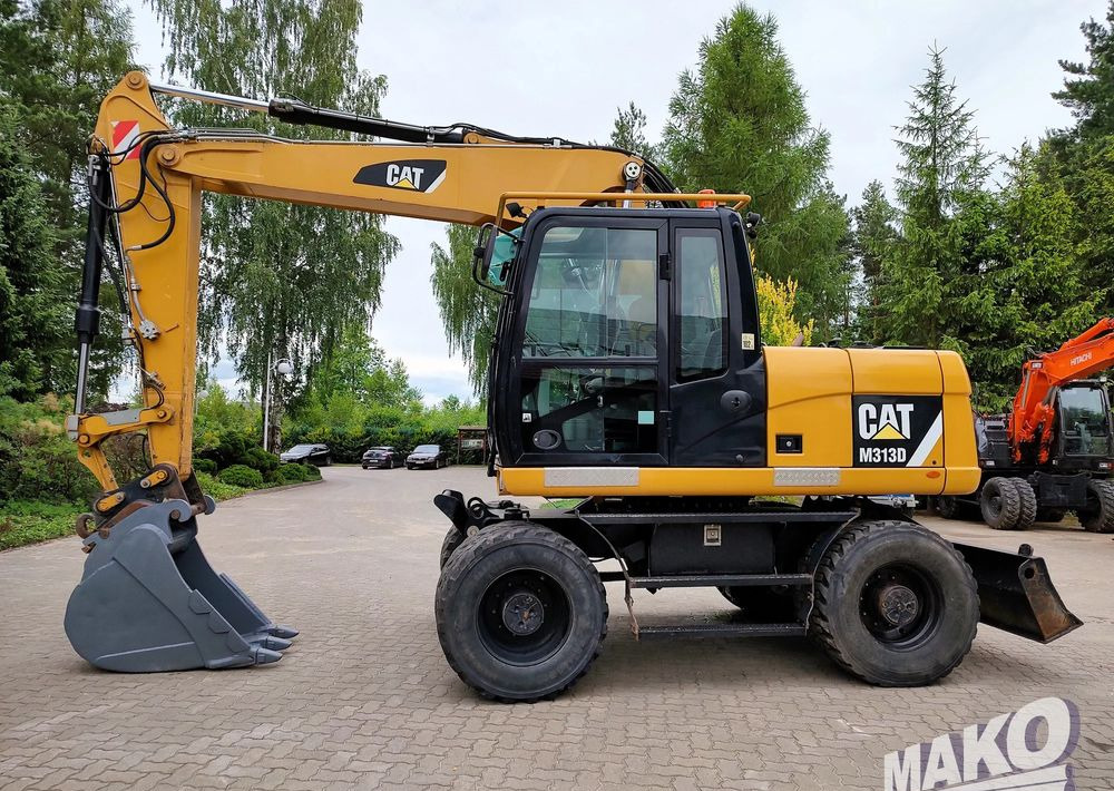 Caterpillar M313D - Ekskavator roda: gambar 1 Caterpillar M313D - Ekskavator roda: gambar 1