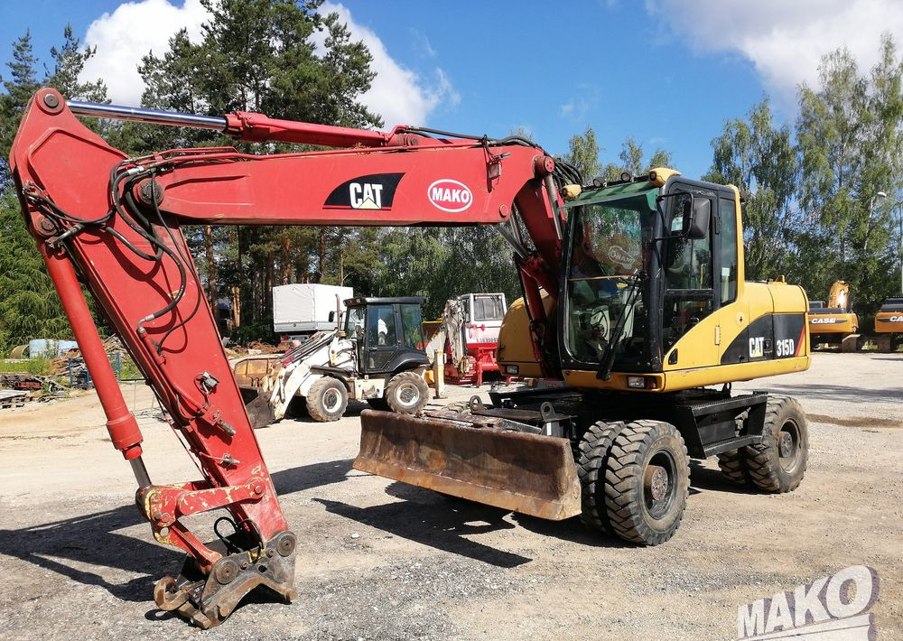 Caterpillar M315 C - Ekskavator roda: gambar 1 Caterpillar M315 C - Ekskavator roda: gambar 1