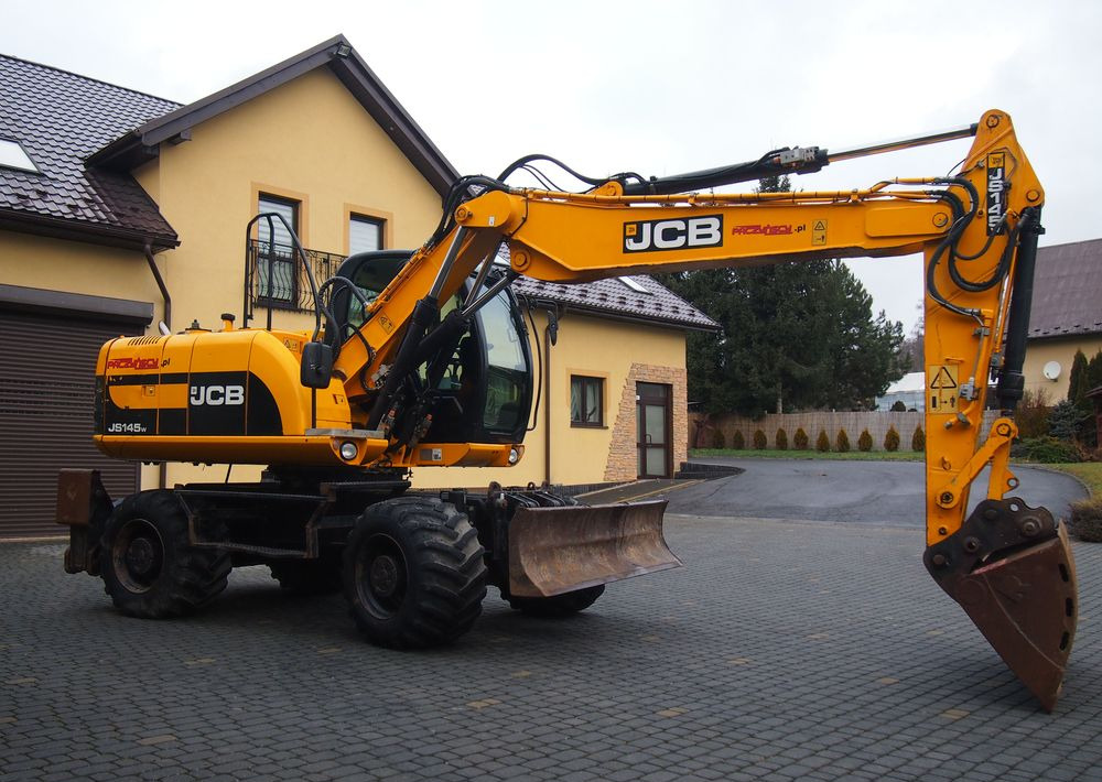 Koparka kołowa JCB JS145W 2011 Koparka JCB - Ekskavator roda: gambar 1 Koparka kołowa JCB JS145W 2011 Koparka JCB - Ekskavator roda: gambar 1