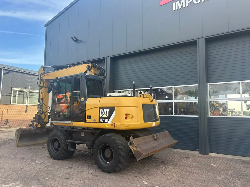 Caterpillar M313D - Ekskavator roda: gambar 2 Caterpillar M313D - Ekskavator roda: gambar 2