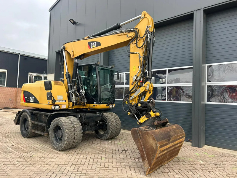 Caterpillar M313D - Ekskavator roda: gambar 3 Caterpillar M313D - Ekskavator roda: gambar 3
