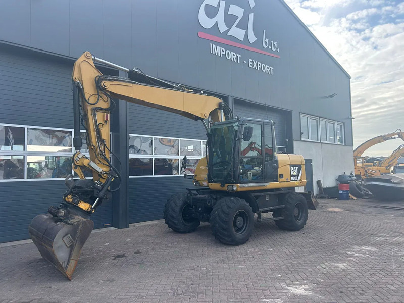Caterpillar M313D - Ekskavator roda: gambar 1 Caterpillar M313D - Ekskavator roda: gambar 1