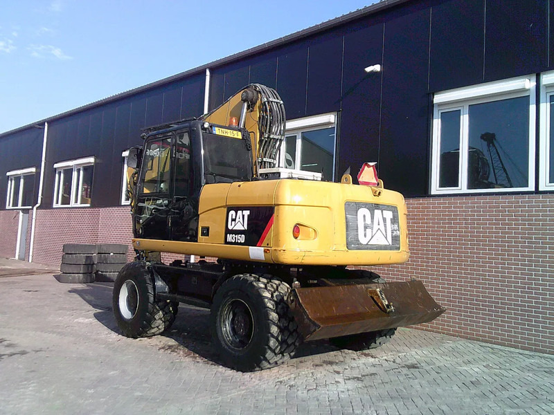 Caterpillar M315D - Ekskavator roda: gambar 2 Caterpillar M315D - Ekskavator roda: gambar 2