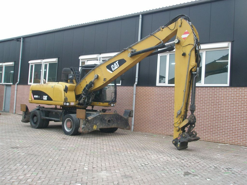 Caterpillar M318D - Ekskavator roda: gambar 3 Caterpillar M318D - Ekskavator roda: gambar 3