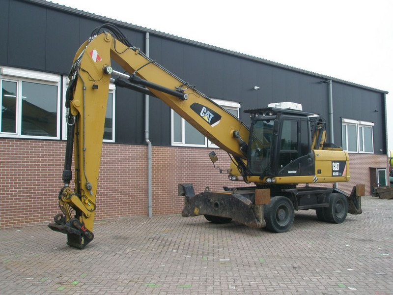 Caterpillar M318D - Ekskavator roda: gambar 1 Caterpillar M318D - Ekskavator roda: gambar 1