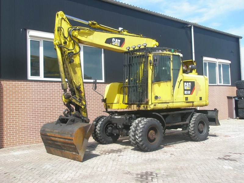 Caterpillar M318F - Ekskavator roda: gambar 1 Caterpillar M318F - Ekskavator roda: gambar 1