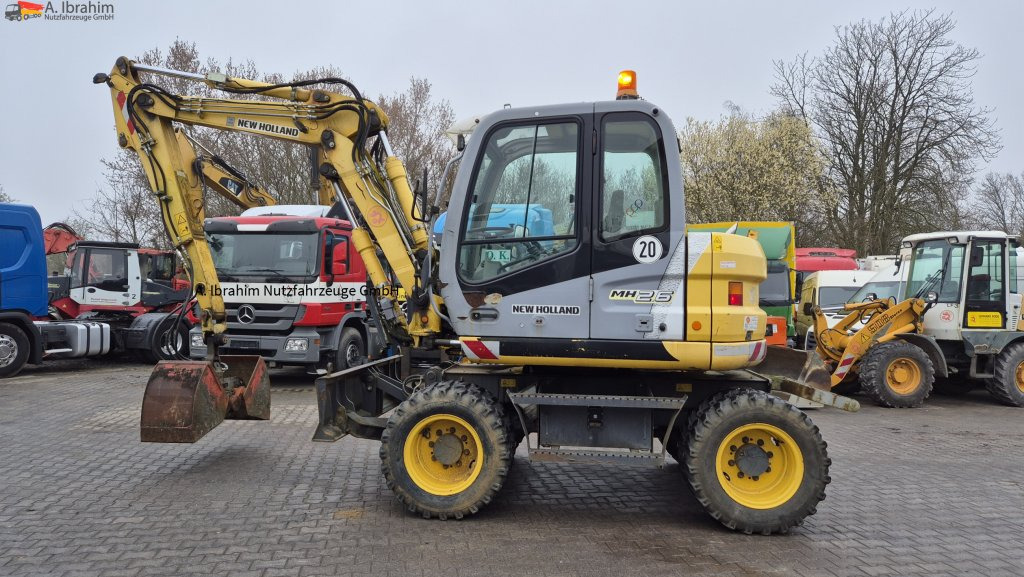 New Holland MH 2.6 Zustand gut, deutsche Maschine incl. Greifer und Dreservo - Ekskavator roda: gambar 1 New Holland MH 2.6 Zustand gut, deutsche Maschine incl. Greifer und Dreservo - Ekskavator roda: gambar 1
