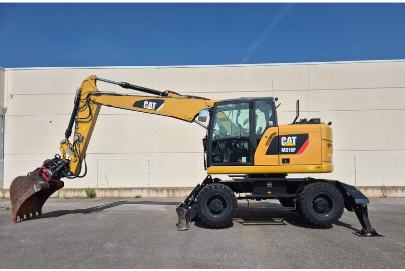 Caterpillar M315F - Ekskavator roda: gambar 1 Caterpillar M315F - Ekskavator roda: gambar 1