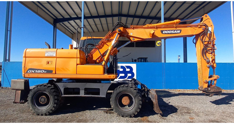 Doosan DX140W-3 - Ekskavator roda: gambar 2 Doosan DX140W-3 - Ekskavator roda: gambar 2