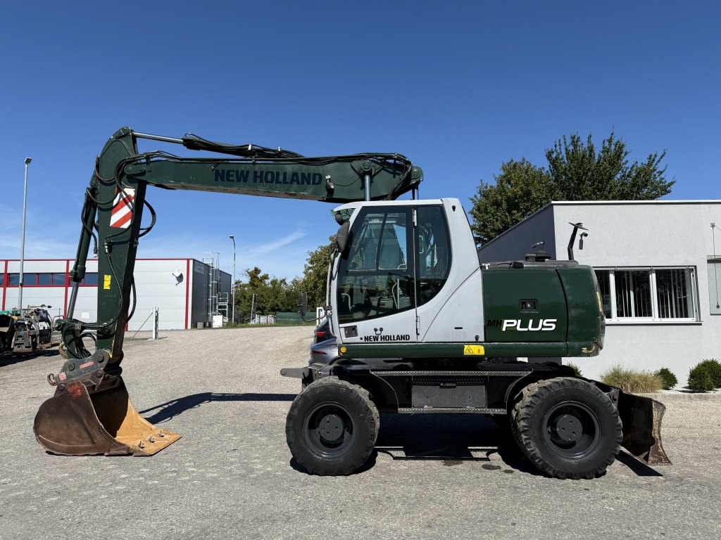 New Holland MH-Plus (111695) - Ekskavator roda: gambar 1 New Holland MH-Plus (111695) - Ekskavator roda: gambar 1