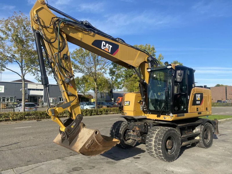 Caterpillar M318F - Ekskavator roda: gambar 1 Caterpillar M318F - Ekskavator roda: gambar 1