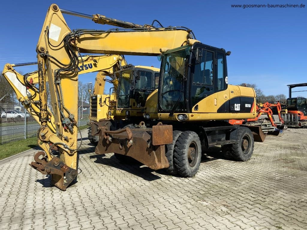 CAT M 315D - Ekskavator roda: gambar 1 CAT M 315D - Ekskavator roda: gambar 1