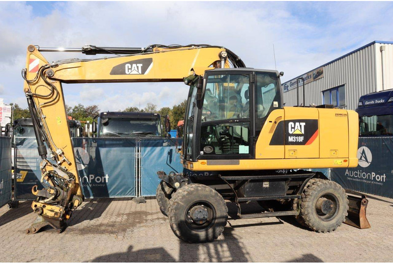Caterpillar M318F - Ekskavator roda: gambar 1 Caterpillar M318F - Ekskavator roda: gambar 1